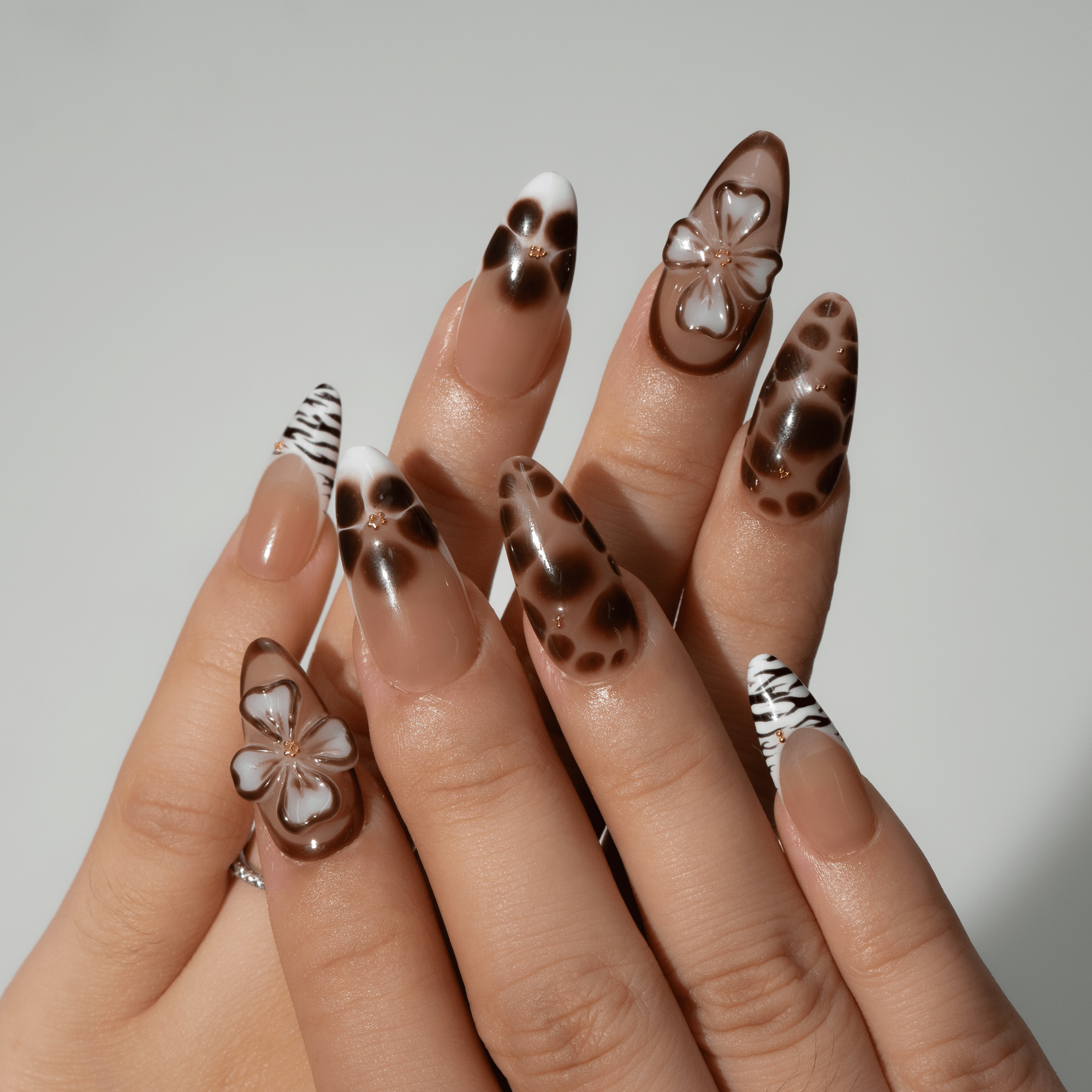 Wild Bloom press-on nails worn on hand – almond shape by Handora